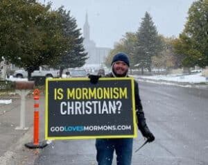 Holding sign: "Is Mormonism Christian?"