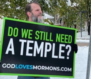 Holding sign: "Do we still need a temple?"